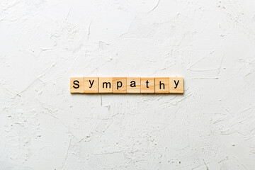 sympathy word written on wood block. sympathy text on table, concept