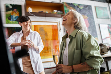 Two woman enjoy wine together.