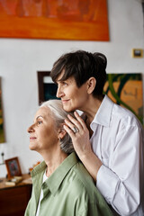 A woman hugged by another woman in a vibrant green shirt.