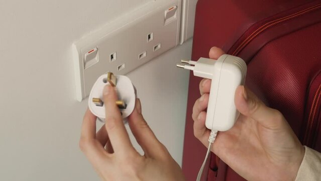 The UK or SG 3 Pin Plug Power converter or travel adapter. The electrical outlet socket in the hotel room