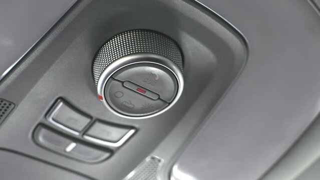 Video of a flashing emergency call (SOS) button in the interior of a car, to contact a call center after a car accident.