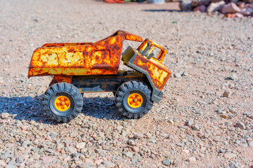 Toy Dump Truck On a Gravel Surface