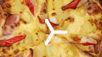 Tropical delight: Savory crab sticks, sweet pineapple, and melted cheese on a pizza create a taste...
