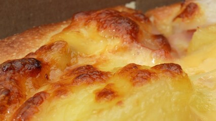 Savor the coastal charm of cheese, pineapple, and crab sticks harmoniously united on this unique and delicious pizza. Process food concept. Pizza background. 
