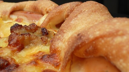 Sizzling perfection: Watch cheese melt over savory sausage in this mouthwatering macro close-up of a delicious pizza. Cooking and recipes concept. Pizza background. 
