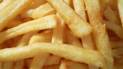 French fries offer a satisfying crunch and a burst of flavor, making them a timeless favorite among food enthusiasts worldwide. Carbohydrate concept. French fries background. 
