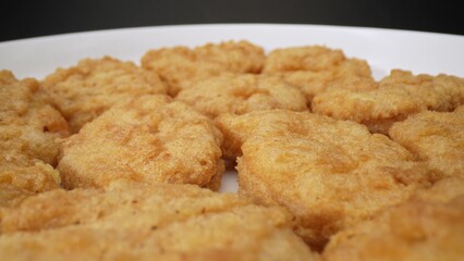 Chicken nuggets are small, battered, and deep-fried pieces of chicken, often served as a fast-food snack or a kid-friendly meal, known for their crispy exterior and tender interior. Food concept. 

