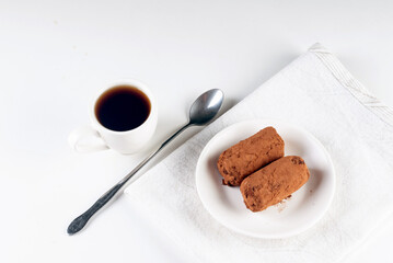 Chocolate Potato Cake. biscuit with cream and cocoa powder on plate. Truffle dessert, sprinkled with cocoa powder,