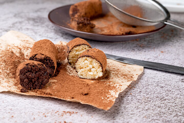 Chocolate Potato Cake. biscuit with cream and cocoa powder on plate. Truffle dessert, sprinkled with cocoa powder,