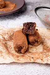 Chocolate Potato Cake. biscuit with cream and cocoa powder on plate. Truffle dessert, sprinkled with cocoa powder,
