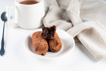 Chocolate Potato Cake. biscuit with cream and cocoa powder on plate. Truffle dessert, sprinkled with cocoa powder,