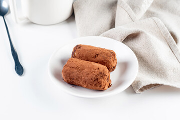 Chocolate Potato Cake. biscuit with cream and cocoa powder on plate. Truffle dessert, sprinkled with cocoa powder,