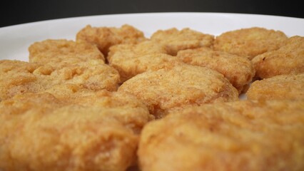 Nuggets are diminutive portions of sustenance, typically composed of minced meat or vegetables, esteemed for their convenience and delectable flavor profile. Food concept. Fast-food background. 
