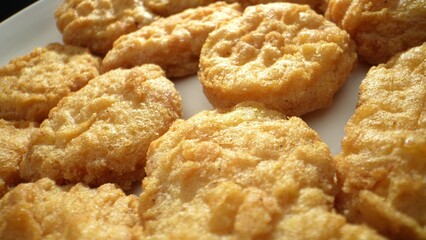 Chicken nuggets made by cutting or grinding chicken, mixed with seasonings, fillers, and binders,...