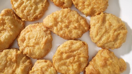 Chicken nuggets are bite-sized pieces of chicken that are breaded and fried until crispy. They are a popular fast food and snack option, loved by both children and adults alike. Food background. 
