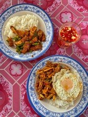 Cuisine Thailand style on top view. Fried prawn with red curry with steamed rice on white plate. Rice topped with stir-fried pork and basil, Rice topped with stir fried minced pork and basil.