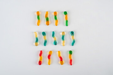Fruit flavored worm shape, jelly candies. Isolated on white background.