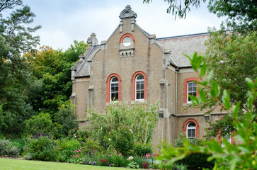 Fototapeta premium The historic Abbotsford Convent building in Melbourne surrounded by beautiful garden plants, it was added to the National Heritage List for its historic value to Australia.