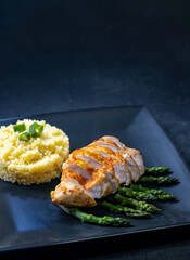 Green asparagus with grilled chicken fillet and couscous