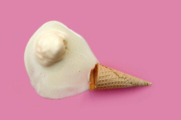 Melting ice cream ball with waffle cone on pink background.