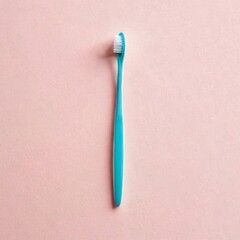 A minimalist image of a single turquoise toothbrush placed on a pastel pink background, emphasizing simplicity and personal hygiene.