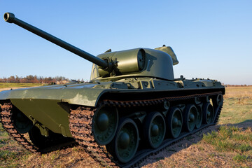 tank in the field. large military green tank stands in a field, close-up, transport concept