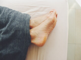feet of a person on a bed