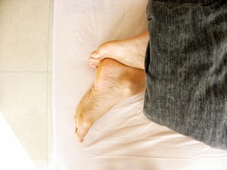 Close up of a woman feet on bed