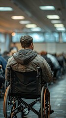 Obraz premium A man sitting in a wheelchair at an airport terminal, waiting for his flight.