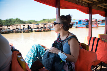 Woman sitting in boat and looking away