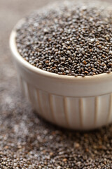 Chia seeds in bowl. Dry healthy supplement for proper nutrition.