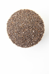 Chia seeds in bowl on white background. Top view. Space for a text