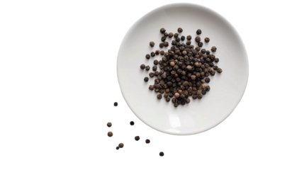 A white plate filled with a generous amount of black pepper, creating a visually striking contrast