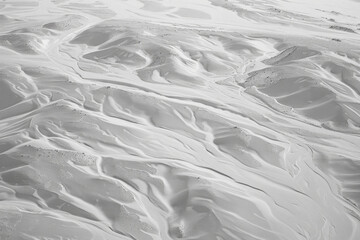 Obraz premium Aerial view of a monochrome tundra landscape, capturing the subtle textures and patterns created by the sparse vegetation and undulating terrain. 