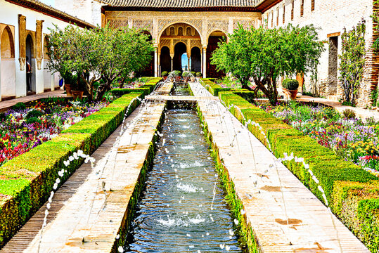 Granada, Spain, April 5, 2024: View of the Patio de la Acequia with its fountains, Generalife Palace of the Alhambra in Granada, Andalucia, Spain