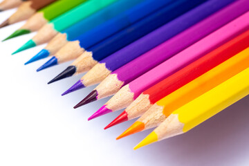 Color pencils that have been sharpened Arranged together according to the hues of the rainbow and photographed close-up. Isolated on a white background