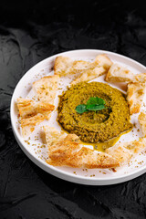 Fresh pesto dip with pita bread on elegant plate