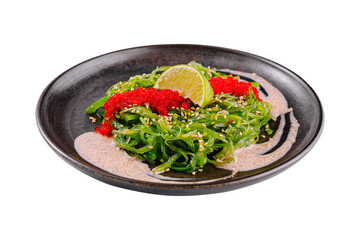 Fresh seaweed salad with tobiko garnish and lime