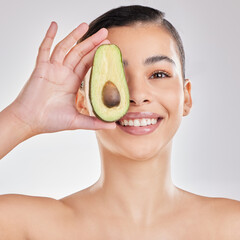 Studio, face and girl with avocado, smile and fruit for skincare, moisturizing and healthy. White...
