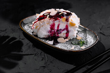 Gourmet pavlova with berry compote and almonds