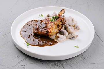 Gourmet pork chop with mushroom sauce on plate