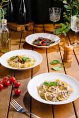 Gourmet italian pasta dishes on rustic wooden table