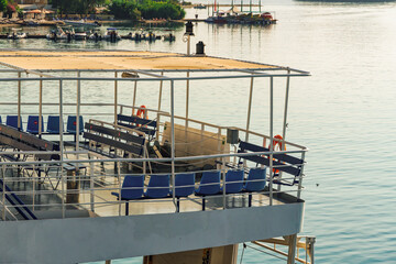 Rear view of car and passengers ferry with empty outdoor seating area, moored in Lefkada Ionian...