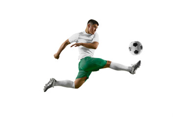 Dynamic portrait of young man, professional soccer player make perfect pass in mid-air against...