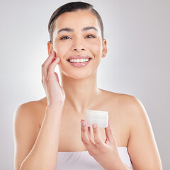 Portrait, skincare and woman in studio with cream, moisturizer and product on white background....
