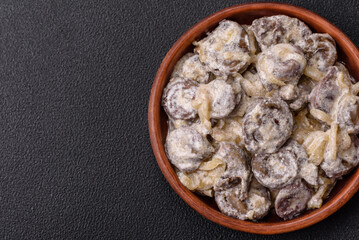 Boiled chicken hearts cut into slices with onions and cream sauce