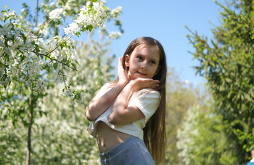 Fototapeta premium Inspired beautiful girl dancing in a sunny park in summer. Outdoor entertainment. Selective focus.