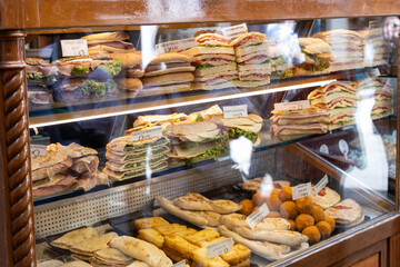Sandwiches and convenience food on a display in a shop window