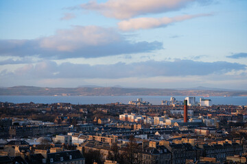 Edinburgh Scotland: 13th Feb 2024: Edinburgh city skyline and Firth of Forth view from Carlton Hill lookout point at dusk