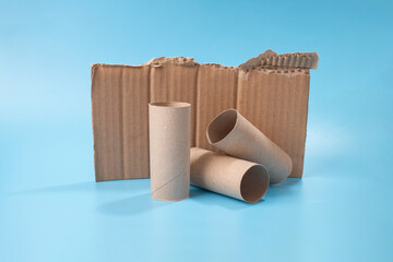 Utilizing a piece of cardboard and recycling empty toilet paper rolls, prepping for a craft project...